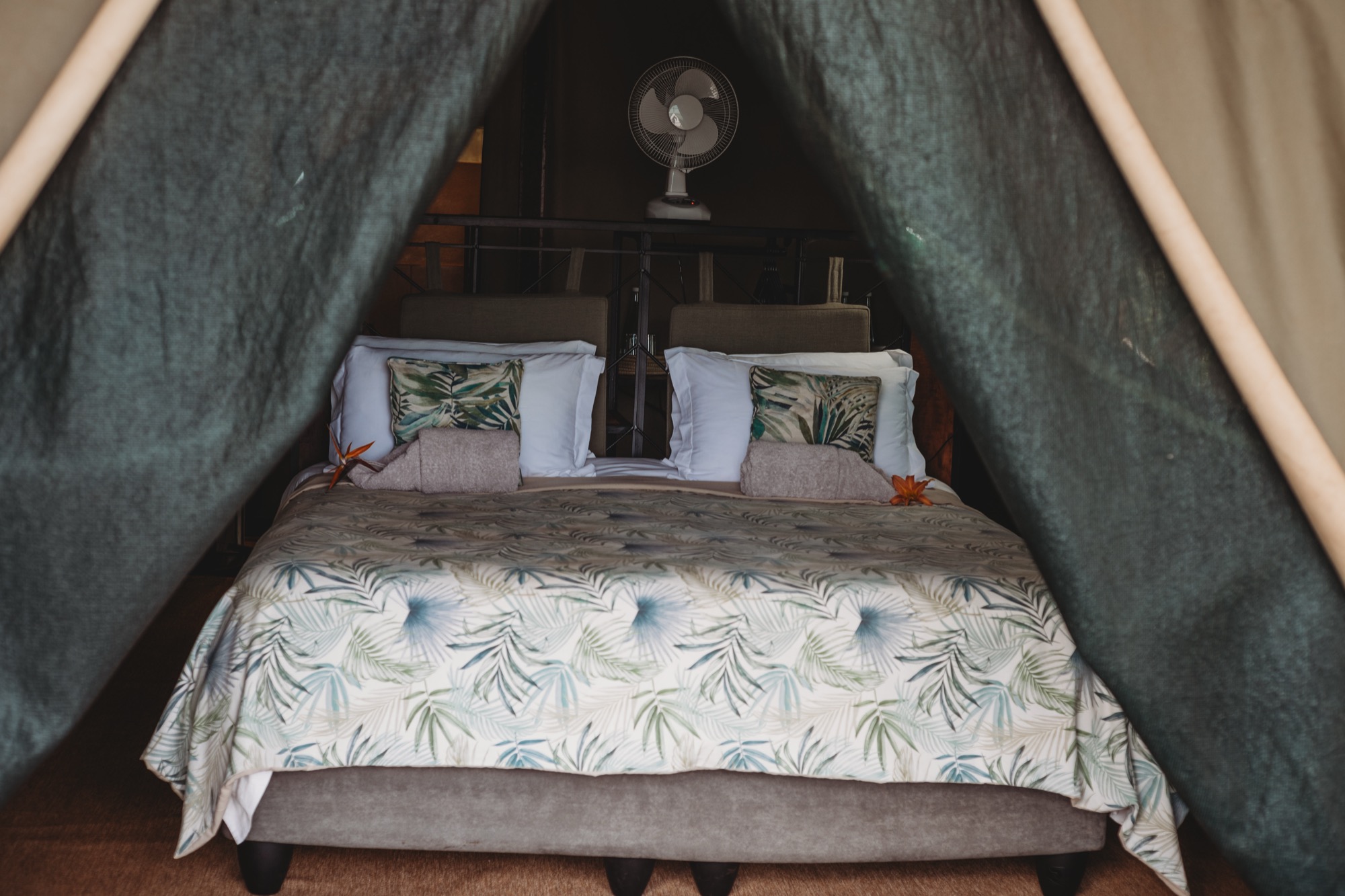 Luxury Tent king bed interior at Romelda Lakeside Retreat